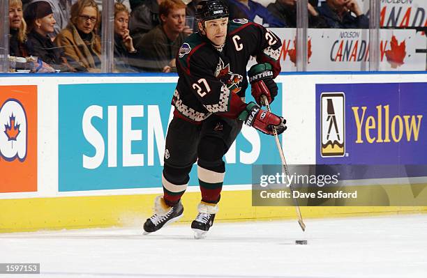 Defenseman Teppo Numminen of the Phoenix Coyotes skates with the puck against the Toronto Maple Leafs during the NHL game on October 17, 2002 at the...