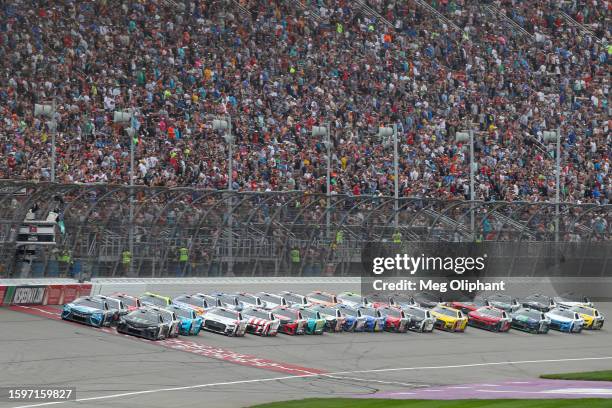 Ty Gibbs, driver of the Monster Energy Toyota, and Martin Truex Jr., driver of the Auto-Owners Insurance Toyota, lead the field to a restart during...