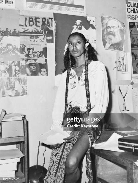 American model and actress Donyale Luna in Italy, 1973. On the wall behind her are pictures of Mahatma Gandhi and Karl Marx.
