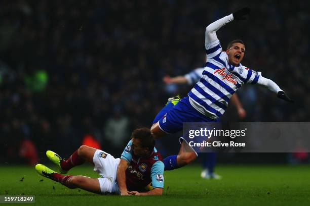 Adel Taarabt of Queens Park Rangers is tackled by Mark Noble of West Ham United during the Barclays Premier League match between West Ham United and...