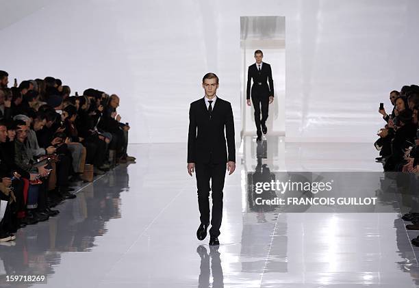 Model displays a creation by Belgian designer Kris Van Assche for the label Dior during the men's Fall-Winter 2013-2014 collection show on January...