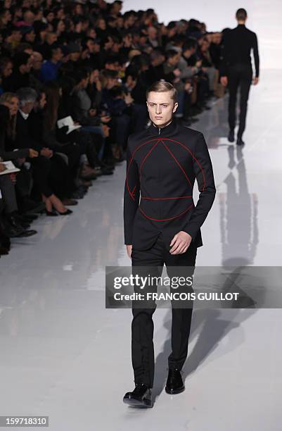 Model displays a creation by Belgian designer Kris Van Assche for the label Dior during the men's Fall-Winter 2013-2014 collection show on January...