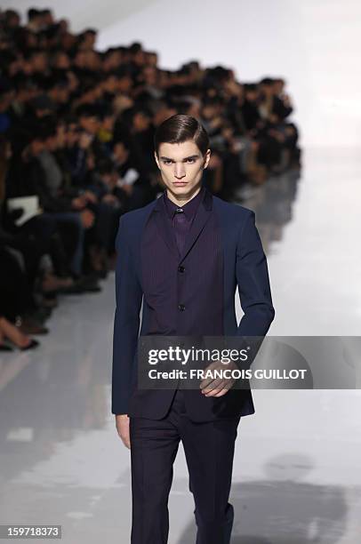 Model displays a creation by Belgian designer Kris Van Assche for the label Dior during the men's Fall-Winter 2013-2014 collection show on January...