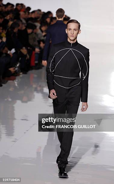 Model displays a creation by Belgian designer Kris Van Assche for the label Dior during the men's Fall-Winter 2013-2014 collection show on January...