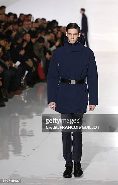 Model displays a creation by Belgian designer Kris Van Assche for the label Dior during the men's Fall-Winter 2013-2014 collection show on January...