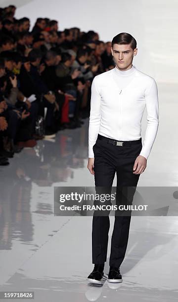 Model displays a creation by Belgian designer Kris Van Assche for the label Dior during the men's Fall-Winter 2013-2014 collection show on January...