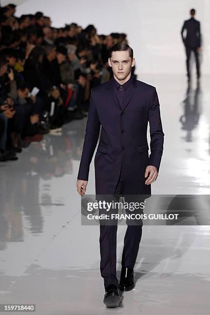 Model displays a creation by Belgian designer Kris Van Assche for the label Dior during the men's Fall-Winter 2013-2014 collection show on January...