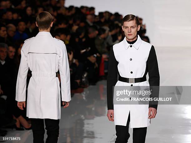 Models display creations by Belgian designer Kris Van Assche for the label Dior during the men's Fall-Winter 2013-2014 collection show on January 19,...