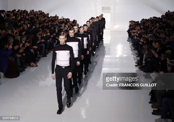 Models display creations by Belgian designer Kris Van Assche for the label Dior during the men's Fall-Winter 2013-2014 collection show on January 19,...