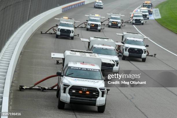 Track Drying Team works to dry the track during a weather delay prior to the NASCAR Cup Series FireKeepers Casino 400 at Michigan International...