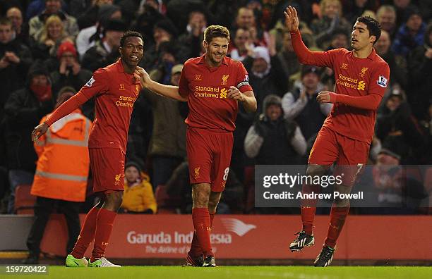 Steven Gerrard of Liverpool celebrates his goal with team-mates Daniel Sturridge and Luis Suarez during the Barclays Premier League match between...