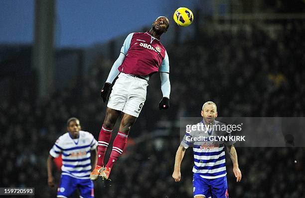 West Ham United's English striker Carlton Cole heads the ball during the English Premier League football match between West Ham United and Queens...