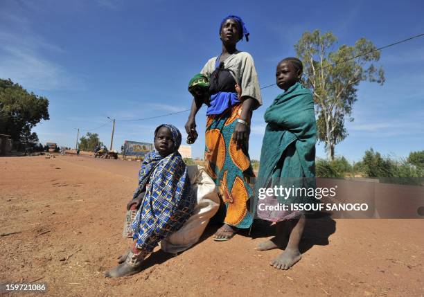 Internally displaced Aminata Foumba arrives near the city of Niono from Diabaly after a six day walk with her children, on January 19 in city of...