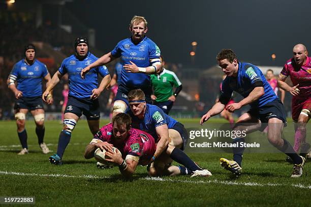 Neil Clark of Exeter Chiefs scoes his sides opening try as Jamie Heaslip of Leinster fails to tackle during the Heineken Cup Pool Five match between...