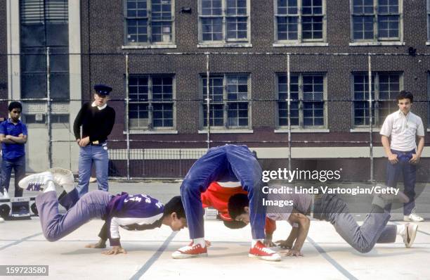 Members of the Rock Steady Crew break-dance in the yard of Booker T. Washington Junior High School , New York, New York, May 8, 1983.