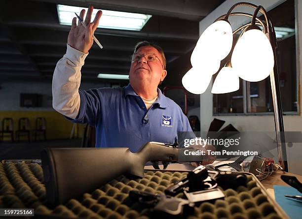 First Presbyterian Church of Dallas volunteer Mike Haney logs the serial number of an unloaded rifle that was being turned in during a gun buy back...