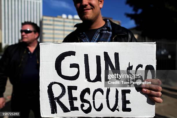 Second Amendment supporter and gun enthusiast displays a sign across the street from a gun buy back program at the First Presbyterian Church of...