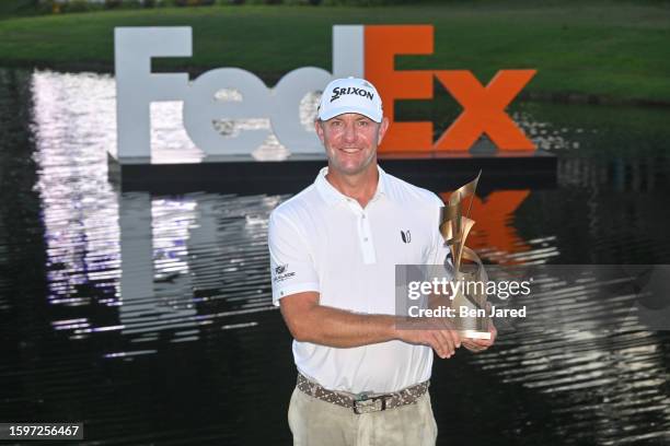 Lucas Glover holds the trophy after the final round of the FedEx St. Jude Championship at TPC Southwind on August 13, 2023 in Memphis, Tennessee.