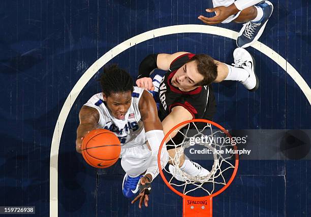 Shaq Goodwin of the Memphis Tigers shoots a layup against Laurent Rivard of the Harvard Crimson on January 19, 2013 at FedExForum in Memphis,...