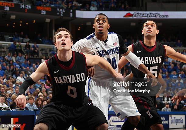 Stephens of the Memphis Tigers is blocked out by Laurent Rivard and Christian Webster of the Harvard Crimson on January 19, 2013 at FedExForum in...