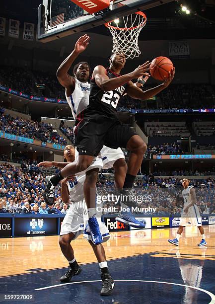 Wesley Saunders of the Harvard Crimson shoots a layup against Shaq Goodwin of the Memphis Tigers on January 19, 2013 at FedExForum in Memphis,...