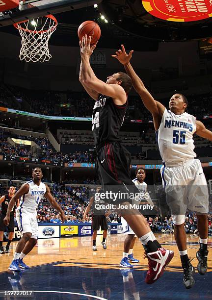 Jonah Travis of the Harvard Crimson drives to the basket for a layup against Geron Johnson of the Memphis Tigers on January 19, 2013 at FedExForum in...