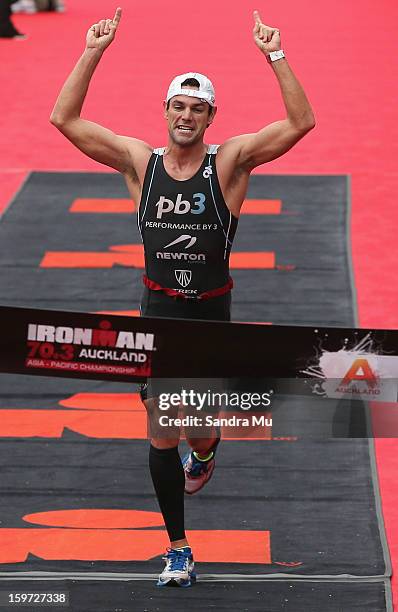 Christian Kemp of Australia celebrates winning the Ironman 70.3 Auckland triathlon on January 20, 2013 in Auckland, New Zealand.