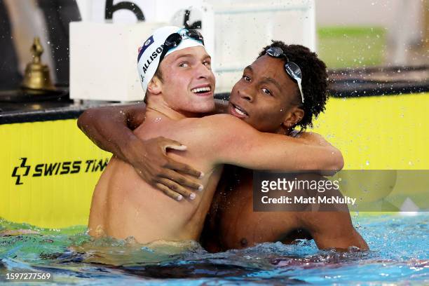 Nikoli Blackman of Team Trinidad & Tobago celebrates with James Allison of Team Cayman Islands after victory in the Men's 200m Freestyle Final on day...