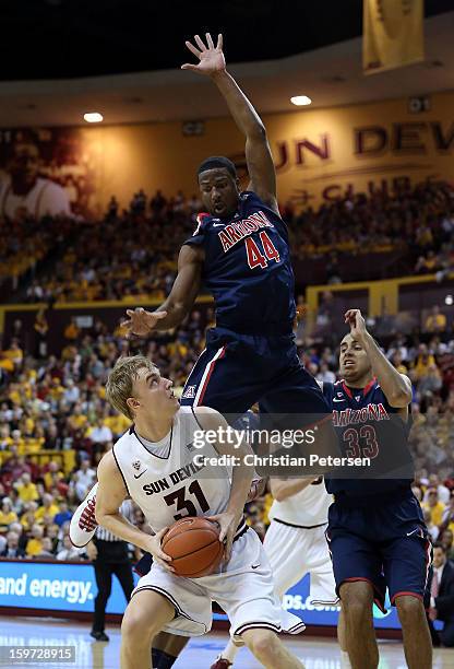 Jonathan Gilling of the Arizona State Sun Devils looks to the basket Arizona State Sun Devils Solomon Hill of the Arizona Wildcats defends during the...