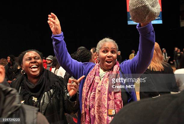 Enid Rogers of Sierra Leone, left, laughs at her friend Ellena Barnett of Washingon, D.C. As Barnett dances during the MLK National Day of Service at...