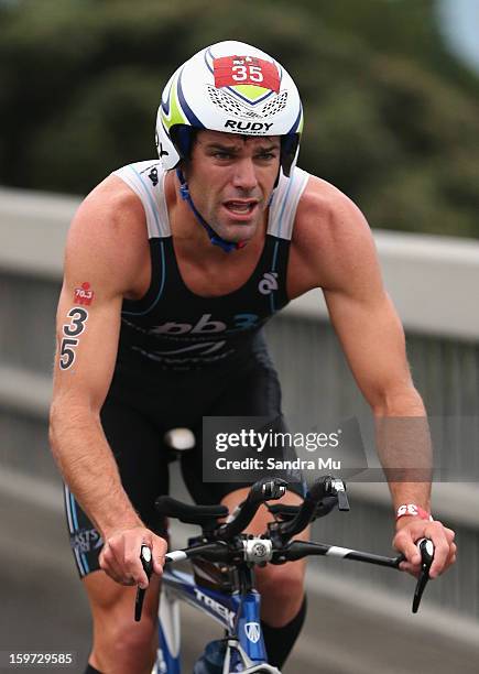 Christian Kemp of Australia cycles over the Auckland Harbour Bridge during the Ironman 70.3 Auckland triathlon on January 20, 2013 in Auckland, New...