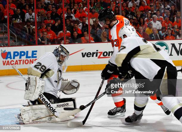 Craig Adams of the Pittsburgh Penguins snags the puck from Jakub Voracek of the Philadelphia Flyers in front of Marc-Andre Fleury of the Penguins at...