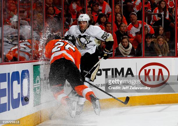 Maxime Talbot of the Philadelphia Flyers crashes into the boards in front of Kris Letang of the Pittsburgh Penguins at Wells Fargo Center on January...