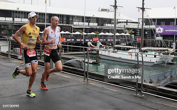 Clark Ellice and Bevan Docherty of New Zealand run around Princes Wharf during the Ironman 70.3 Auckland triathlon on January 20, 2013 in Auckland,...