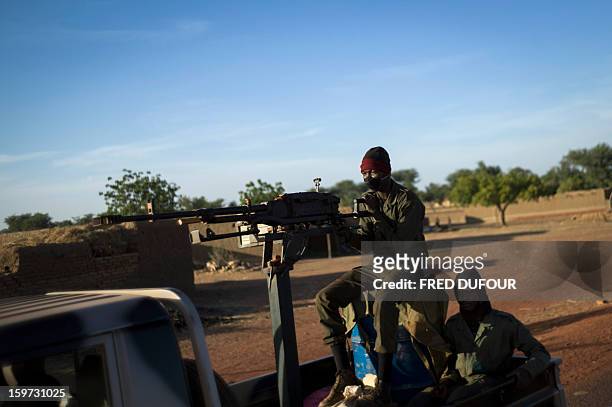Malian soldier holds a machine gun in a jeep on the road back from Mopti, on January 19, 2013 in Kongena. West African leaders Saturday sought urgent...