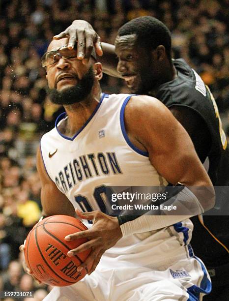 Creighton's Gregory Echenique gets tangled up with Wichita State's Ehimen Orukpe during the first half on Saturday, January 19 at Koch Arena in...