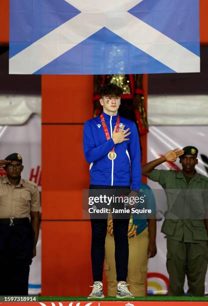 Gold Medallist, Dean Fearn of Team Scotland stands on the podium after finishing 1st Place in the Men's 50m Butterfly on day two of the 2023 Youth...