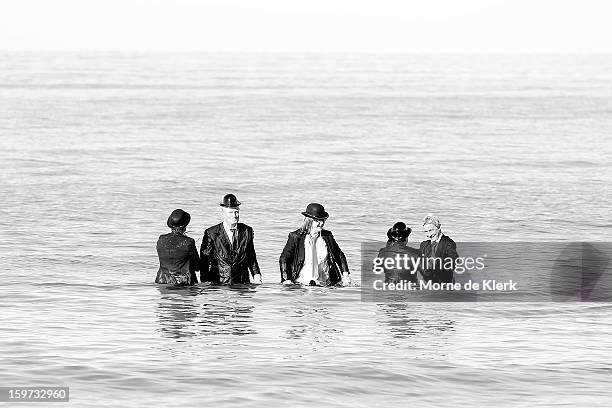 Participants stand in the water after taking part in an art installation created by surrealist artist Andrew Baines on January 20, 2013 in Adelaide,...