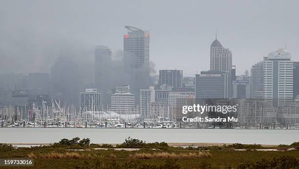 Smoke is seen from an apartment fire in the CBD during the Ironman 70.3 Auckland triathlon on January 20, 2013 in Auckland, New Zealand.