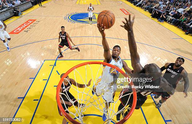 Harrison Barnes of the Golden State Warriors shoots against Joel Anthony of the Miami Heat on January 16, 2013 at Oracle Arena in Oakland,...