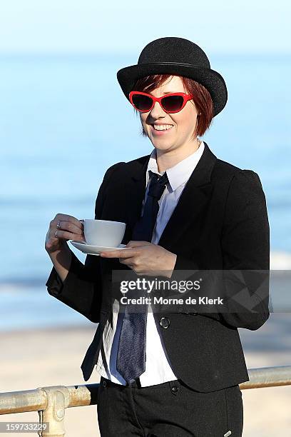 Participants wait before moving onto the beach dressed in suits and bowler hats as part of an art installation created by surrealist artist Andrew...