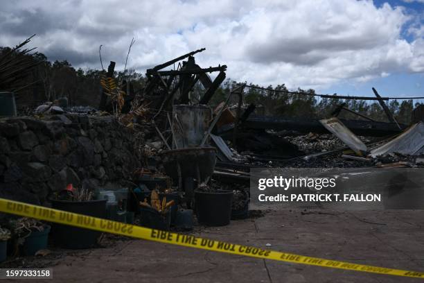 Police tape surrounds the site of a home destroyed by the Maui wildfires in Kula, Hawaii on August 13, 2023. The death toll in Hawaii from the...