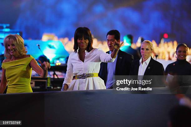 The First Lady Michelle Obama and Jill Biden head to the stage during the children's concert at the Washington Convention Center to celebrate...