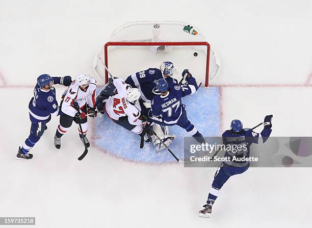 Joel Ward of the Washington Capitals scores a goal past Anders Lindback of the Tampa Bay Lightning and defenseman Victor Hedman at the Tampa Bay...