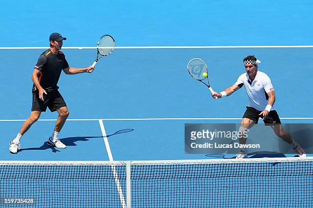 Pat Cash and Wayne Arthurs of Australia play a shot in their first round legends match against Thomas Enqvist of Sweden Fabrice Santoro of France...