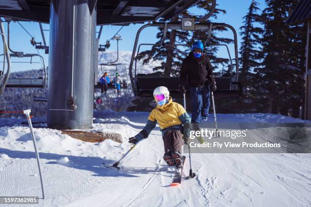 adaptive athletes getting off ski lift - disabled skier stock pictures, royalty-free photos & images