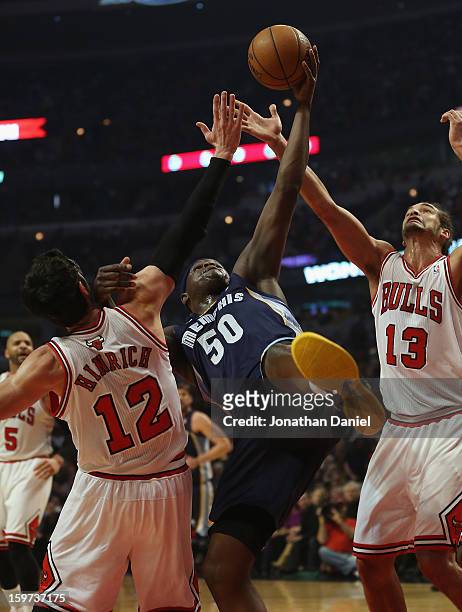 Zach Randolph of the Memphis Grizzles tries to rebound between Kirk Hinrich and Joakim Noah of the Chicago Bulls at the United Center on January 19,...