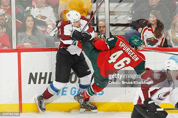 John Mitchell of the Colorado Avalanche checks Jared Spurgeon of the Minnesota Wild during the game on January 19, 2013 at the Xcel Energy Center in...