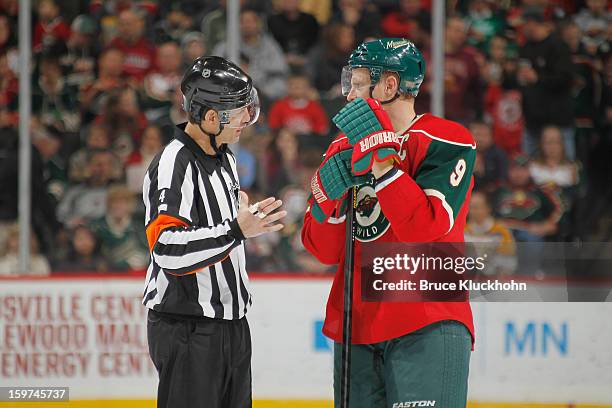 Mikko Koivu of the Minnesota Wild talks with Referee Wes McCauley during a break in the game against the Colorado Avalanche on January 19, 2013 at...