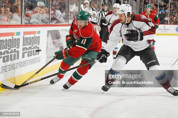 Zach Parise of the Minnesota Wild and Ryan Wilson of the Colorado Avalanche battle for control of the puck during the game on January 19, 2013 at the...